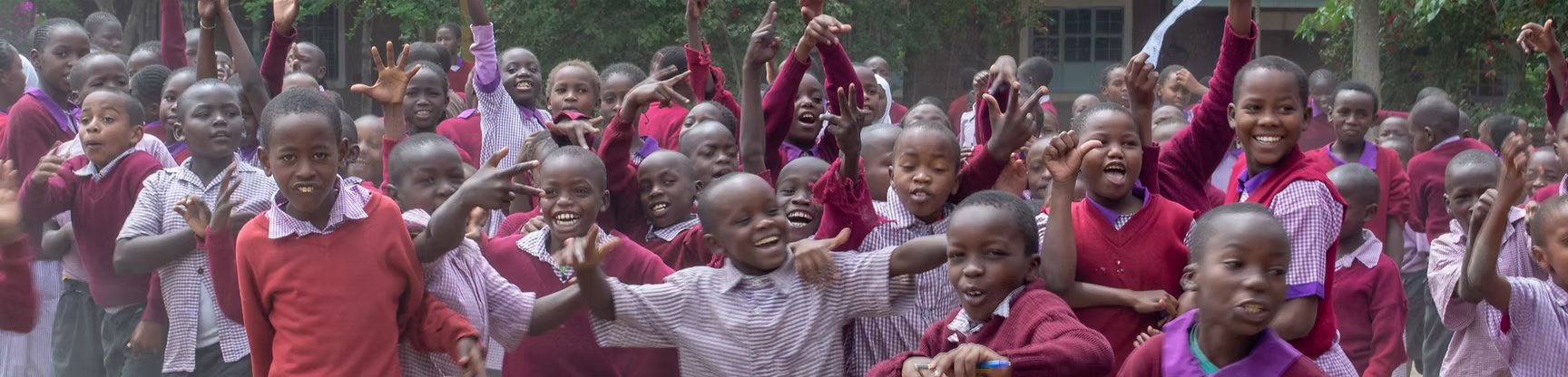 Students at Every Child Counts cheering in the school yard, Karachi, Pakistan